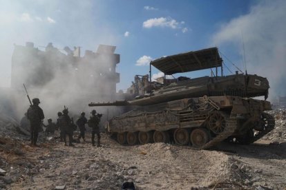 Israeli soldiers next to an armored vehicle in Gaza,