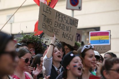 Imagen de archivo de una mujer sosteniendo una pancarta en la que se lee "Las personas trans también existen en Córcega" durante la marcha del orgullo LGBT "Marcha de la libertad", la primera de este tipo en Bastia, en la isla mediterránea francesa de Córcega, el 17 de junio de 2023.