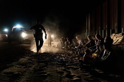 Border Patrol agents in Yuma guard a group of detained illegal immigrants.