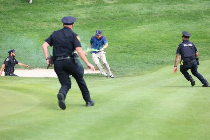 CROMWELL, CT - JUNE 23: Protesters run onto the 18th green during the final round of the 2024 Travelers Championship on June 23, 2024, at TPC River Highlands in Cromwell, CT. (Credit Image: © Mingo Nesmith/Icon SMI via ZUMA Press)