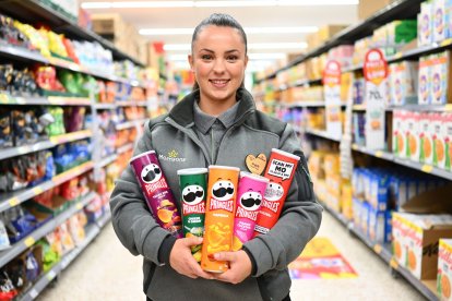 EDITORIAL USE ONLY Team member at Morrisons Stratford, Angela holds tubs of Pringles as the supermarket launches a new deal on the crisps for More Card holders. Issue date: Wednesday September 12, 2023.