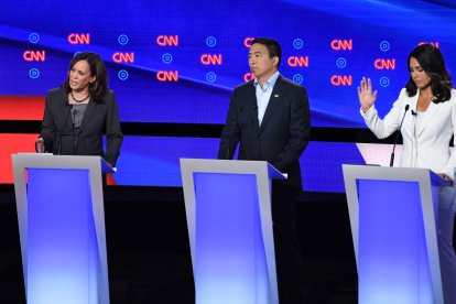 Democratic presidential hopefuls US Senator from California Kamala Harris (L), US entrepreneur Andrew Yang (C) and US Representative for Hawaii's 2nd congressional district Tulsi Gabbard (R) speak during the second round of the second Democratic primary debate of the 2020 presidential campaign season hosted by CNN at the Fox Theatre in Detroit, Michigan on July 31, 2019. (Photo by Jim WATSON / AFP)