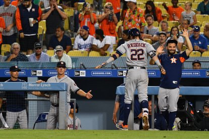 El jardinero derecho de los Astros de Houston Josh Reddick es saludado por el segunda base de los Astros de Houston José Altuve