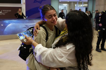 A fan of Maccabi Tel-Aviv is met by a family member at the Ben Gurion International Airport