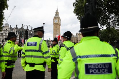 Police officers secure an intersection in front of the Palace of Westminster