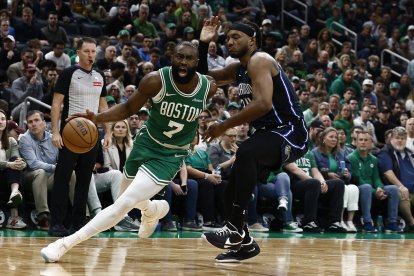 Apr 23, 2025; Boston, Massachusetts, USA; Boston Celtics guard Jaylen Brown (7) drives past Orlando Magic center Wendell Carter Jr. (34) during the second half of game two of the first round of the 2024 NBA Playoffs at TD Garden