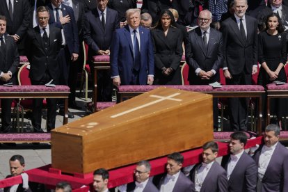 Pope Francis' coffin is carried in front of dignitaries, including President Donald Trump