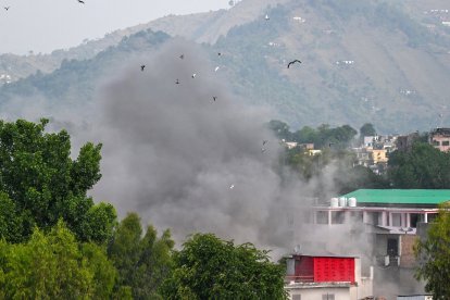 Smoke billows after an artillery shell landed in the main town of Poonch district in India's Jammu region on May 7, 2025. At least eight Indians were killed and 29 others wounded Wednesday in the town of Poonch in Kashmir, close to the de facto border with Pakistan, a local Indian government official said. (Photo by Punit PARANJPE / AFP)