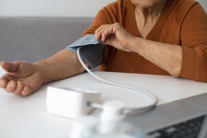 An older woman has her blood pressure taken