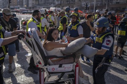 Israeli paramedics assist a woman injured following an Iranian attack.