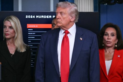 US President Donald Trump (C) looks on, alongside Attorney General Pam Bondi (L) and US Attorney for the District of Columbia Jeanine Pirro (R), during a news conference to discuss crime in Washington, DC, in the Brady Press Briefing Room at the White House in Washington, DC, on August 11, 2025. President Donald Trump announced Monday that he was deploying National Guard troops and putting the Washington police force under federal control to tackle crime in the US capital. "This is Liberation Day in DC, and we're going to take our capital back," Trump said at a White House press conference. (Photo by ANDREW CABALLERO-REYNOLDS / AFP)