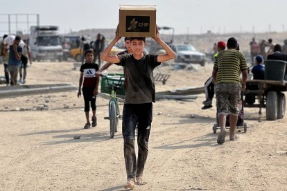 Palestinians receive humanitarian aid in Gaza.