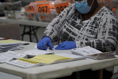 October 26, 2020, Lawrenceville, Georgia, USA: Absentee ballot processing could begin GeorgiaÃs counties15 days before Election Day and can continue by state law until November 13. After the information on the outer envelop is verified, the ballots are bundled together for processing. This next steps include opening the outer envelope, removing the ballot from the secrecy sleeve, separating the envelopes from the ballots, and counting to make sure that the total number of ballots and envelopes are the same. (Credit Image: © Sue Dorfman/ZUMA Wire)