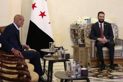 Syria's interim President Ahmad al-Sharaa (R) receives US Special Envoy to Syria Thomas Barrack, at the presidential palace in Damascus on July 9, 2025