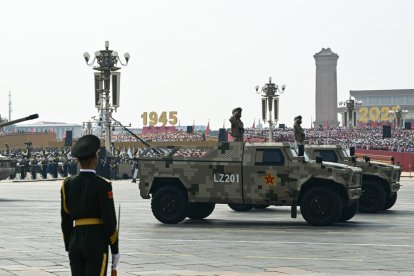 Military vehicles roll during a military parade marking the 80th anniversary of victory over Japan and the end of World War II, in Beijings Tiananmen Square on September 3, 2025. (Photo by GREG BAKER / AFP)