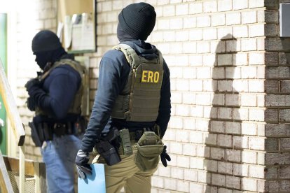 U.S. Immigration and Customs Enforcement officers wait to detain a person, Monday, Jan. 27, 2025, in Silver Spring, Md. (AP Photo/Alex Brandon)