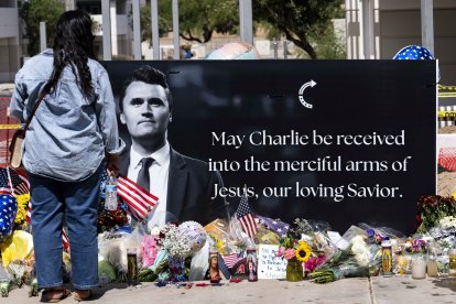 People gather outside the headquarters of Turning Point USA to mourn the loss of Charlie Kirk