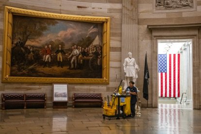 A member of the cleaning staff makes her way through the Rotunda on an empty US Capitol in Washington, DC on September 30, 2025, hours before a partial government shutdown is set to take effect. The US government barreled towards its first shutdown in six years Tuesday, with funding expiring at midnight after Democrats fought a war of words with Donald Trump and senators rejected a last-ditch bid to keep the lights on. (Photo by ANDREW CABALLERO-REYNOLDS / AFP)
