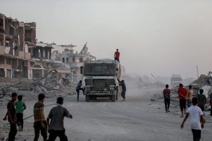 Trucks carrying humanitarian aid drive through Khan Younis, in the southern Gaza Strip