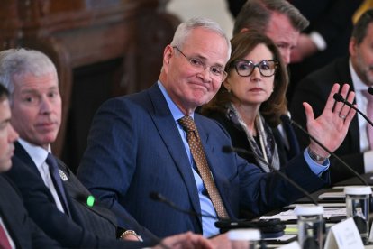 ExxonMobil CEO Darren Woods (C) attends a meeting with US President Donald Trump and oil company executives in the East Room of the White House in Washington, DC on January 9, 2026. President Trump is aiming to convince oil executives to support his plans in Venezuela, a country whose energy resources he says he expects to control for years to come. US forces seized Venezuelan president Nicolas Maduro in a sweeping military operation on January 3, with Trump making no secret that control of Venezuela's oil was at the heart of his actions. (Photo by Brendan SMIALOWSKI / AFP)
