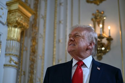 US President Donald Trump arrives to take part in a dedication ceremony for Southern Boulevard, in the ballroom at Mar-a-Lago in Palm Beach, Florida, on January 16, 2026. (Photo by ANDREW CABALLERO-REYNOLDS / AFP)