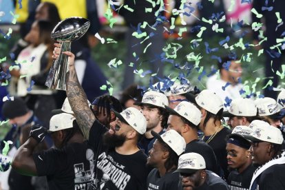 Seattle Seahawks' players celebrate with the Vince Lombardi Trophy after defeating the New England Patriots during Super Bowl LX at Levi's Stadium in Santa Clara, California on February 8, 2026. (Photo by Patrick T. Fallon / AFP)