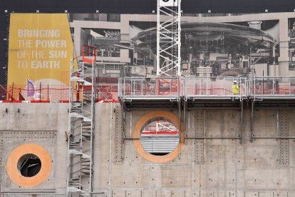 Employees work outside the ITER (International Thermonuclear Experimental Reactor) construction site where the Tokamak will be installed, a confinement device being developed to produce controlled thermonuclear fusion power, in Saint-Paul-les-Durance, southern France on October 10, 2018.
