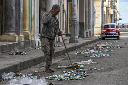 Un hombre intenta limpiar las calles de La Habana