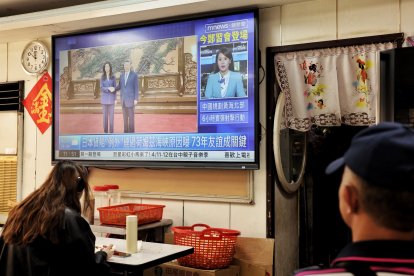 Un televisor muestra la reunión entre la presidenta del Kuomintang (KMT), Cheng Li-wun, y el presidente chino Xi Jinping