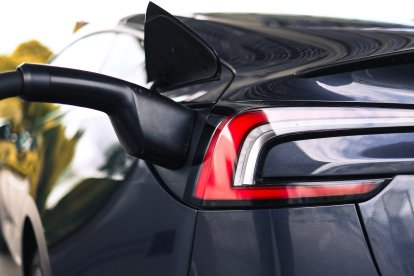 A photo shows an electric car connected to a Tesla charging station (Files)