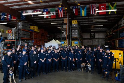 Members of the County of Los Angeles Fire Departments international urban search and rescue team (USA-2) prepare to leave for Venezuela, in Pacoima, California on June  25, 2026. The County of Los Angeles Fire Departments international urban search and rescue team (USA-2) will departs in response to the Venezuela earthquakes. 71 crew members alongside 6 dogs will be sent to Venezuela to aid in search and rescue efforts. The United States said Thursday it was mobilizing $150 million in aid for Venezuela after two powerful earthquakes killed at least 188 people and left hundreds injured, as rescuers around the world raced to provide help. (Photo by Blake Fagan / AFP)