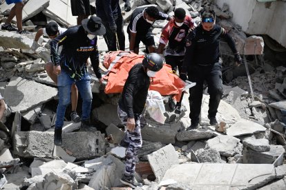Los voluntarios rescatan cuerpos atrapados entre los escombros tras el terremoto en Venezuela