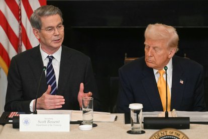 US President Donald Trump listen to US Secretary of Treasury Scott Bessent
