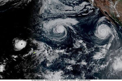 This handout satellite image obtained from the National Oceanic and Atmospheric Administration (NOAA)/GOES shows Hurricane Lowell (L).