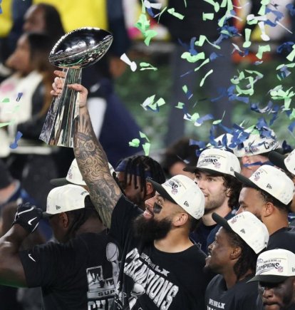 Seattle Seahawks' players celebrate with the Vince Lombardi Trophy after defeating the New England Patriots during Super Bowl LX at Levi's Stadium in Santa Clara, California on February 8, 2026. (Photo by Patrick T. Fallon / AFP)