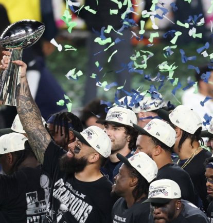 Seattle Seahawks' players celebrate with the Vince Lombardi Trophy after defeating the New England Patriots during Super Bowl LX at Levi's Stadium in Santa Clara, California on February 8, 2026. (Photo by Patrick T. Fallon / AFP)