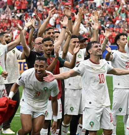 Moroccan players celebrate after their victory over Canada/ Ronaldo Schemidt