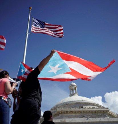 Imagen de archivo y de referencia que muestran manifestantes con la bandera de Puerto Rico