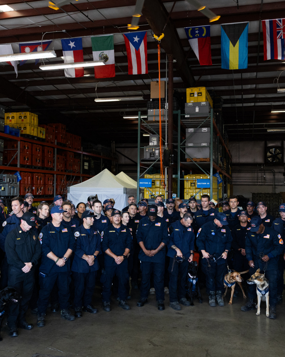 Members of the County of Los Angeles Fire Departments international urban search and rescue team (USA-2) prepare to leave for Venezuela, in Pacoima, California on June 25, 2026. The County of Los Angeles Fire Departments international urban search and rescue team (USA-2) will departs in response to the Venezuela earthquakes. 71 crew members alongside 6 dogs will be sent to Venezuela to aid in search and rescue efforts. The United States said Thursday it was mobilizing $150 million in aid for Venezuela after two powerful earthquakes killed at least 188 people and left hundreds injured, as rescuers around the world raced to provide help. (Photo by Blake Fagan / AFP)
