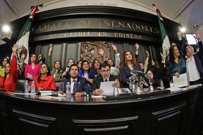 Members of Mexico's Senate celebrate after approving controversial judicial reform.