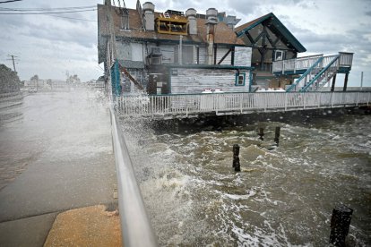 Waves crash against a building ahead of Hurricane Helene's landfall in Cedar Key, Fla.