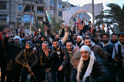 Civilians and rebels celebrate as they gather in the Damascus suburb of Jaramana.