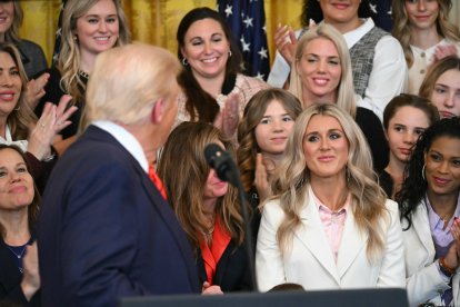Trump and activist Riley Gaines cross glances.