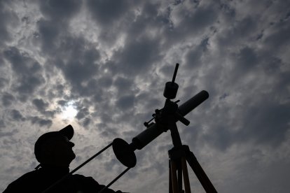 Un hombre mira el eclipse solar parcial en Frankfurt (Alemania)
