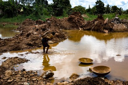 A child miner works in an open-pit mine in search of gold to later sell in El Callao