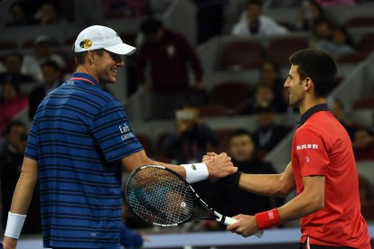 John Isner and Novak Djokovic greet each other after playing a match in 2015