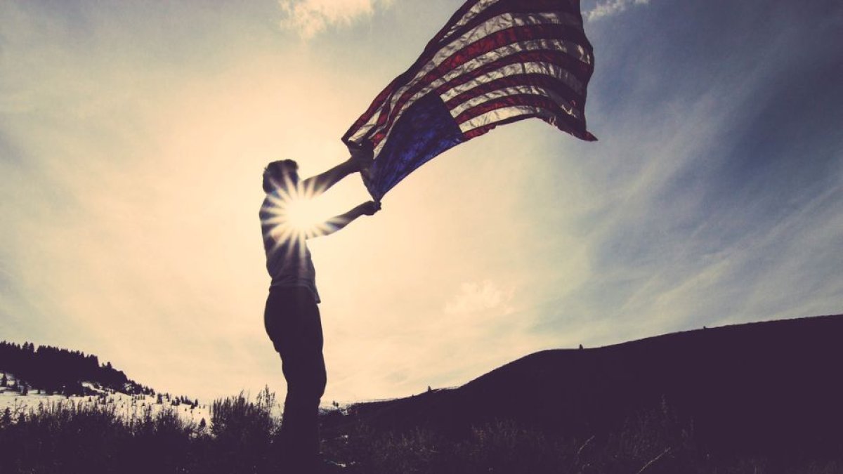 A man waves a US flag.