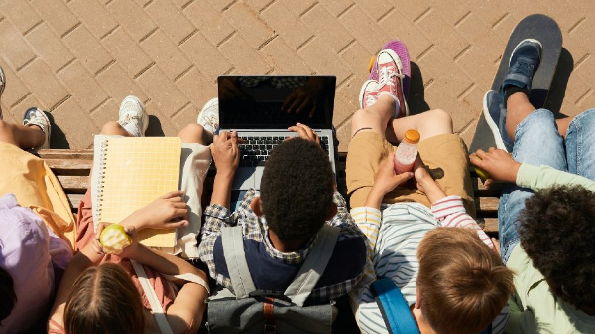 Niños en una escuela jugando con un ordenador con acceso a las redes sociales.