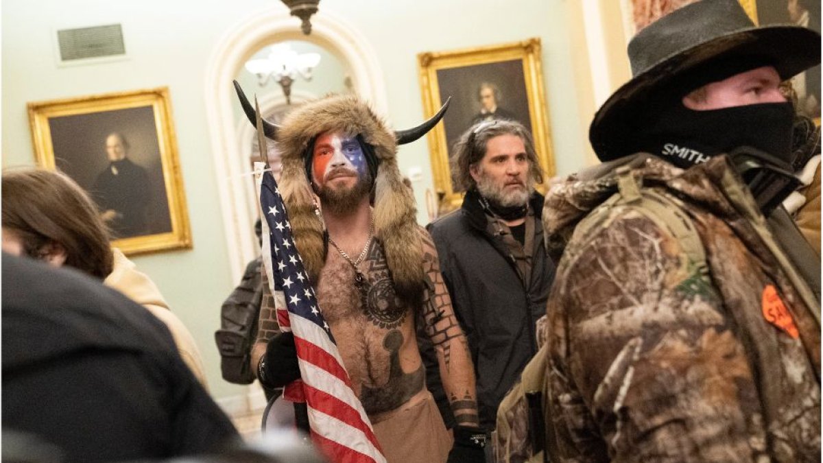 Jake Angeli the QAnon Shaman joins protesters as they storm the Capitol