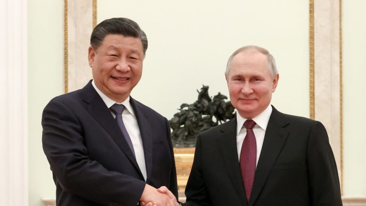 China's President Xi Jinping and his Russian counterpart Vladimir Putin shake hands during a meeting at the Moscow Kremlin.